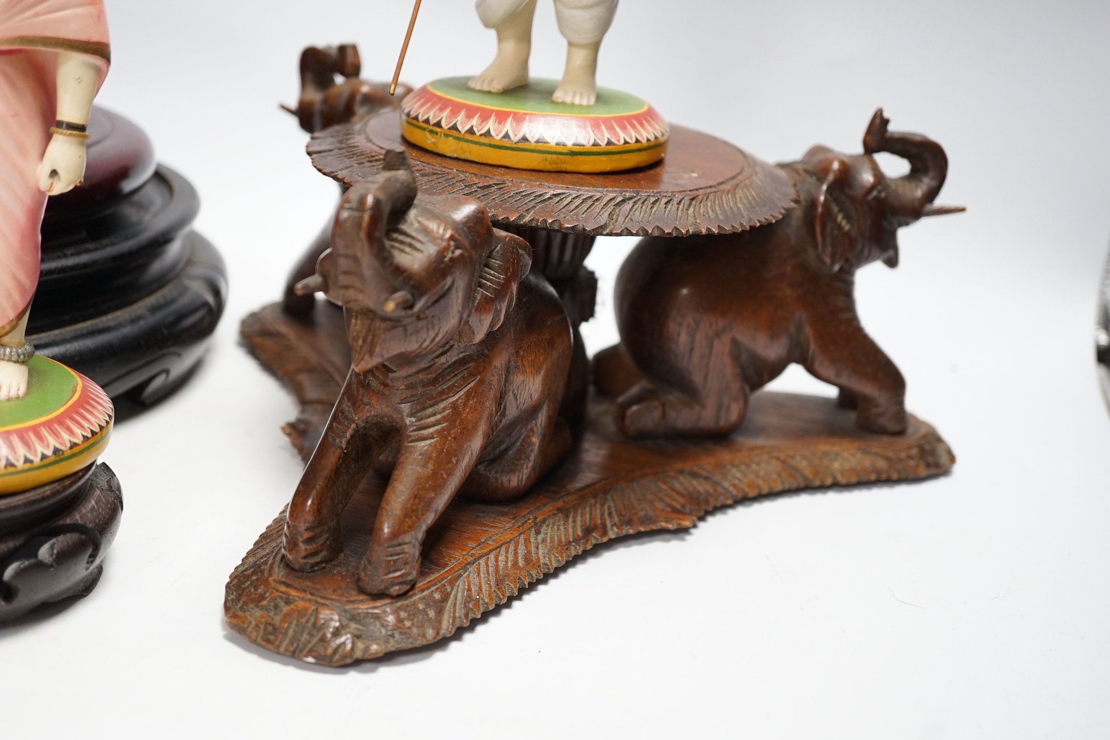 Two Indian carved and painted wood figures, an Indian or Burmese carved wood stand another various wood stands, largest 24cm in diameter